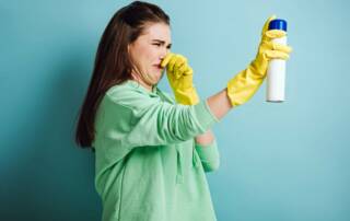 women glove spraying for bad smell
