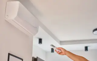 hand-using-remote-control-to-adjust-temperature-on-2025-07-15-01-51-29-utc